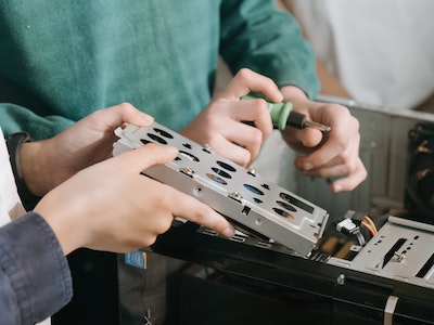 Two people looking at electronic parts