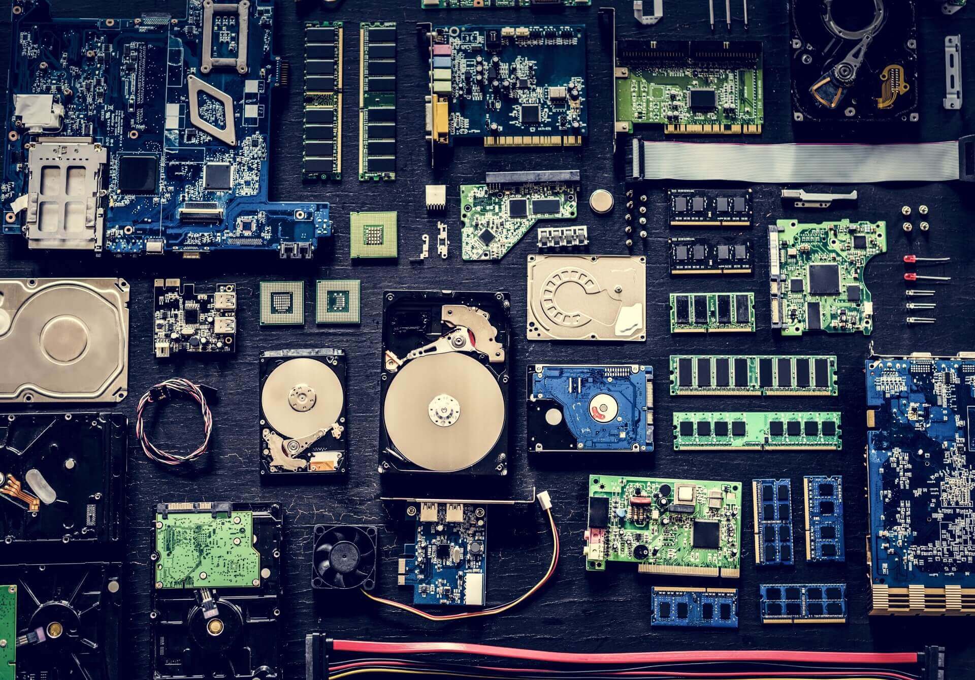 Multiple computer parts laying neatly on a table.